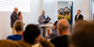 Nobel Peace Prize laureate Dmitry Muratov delivers a speech to an audience.